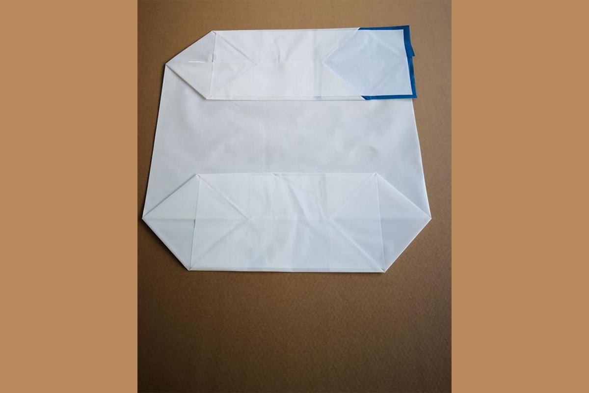 White PE valve bag on a brown work surface